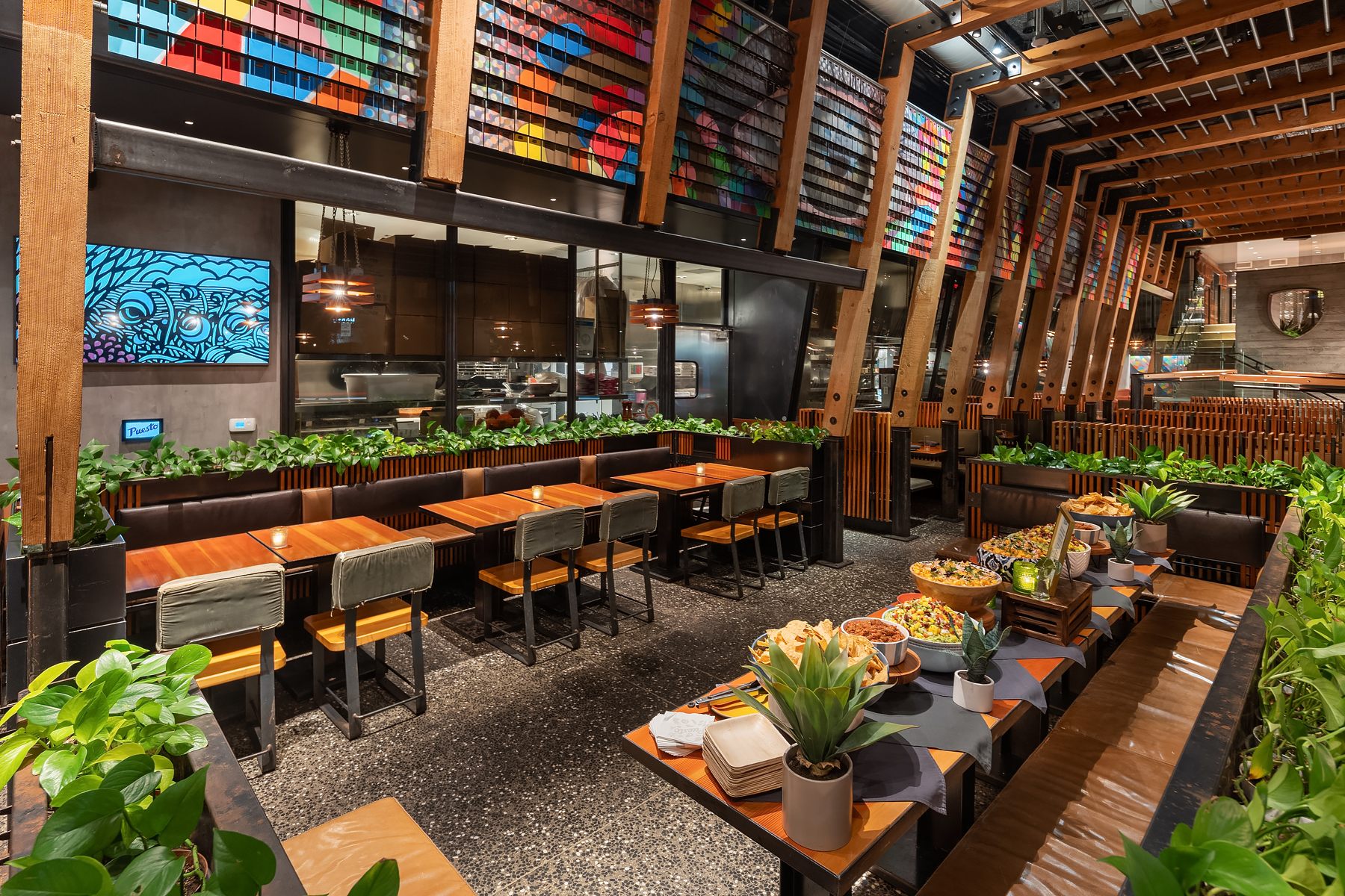 a group of people sitting at a table in front of a building