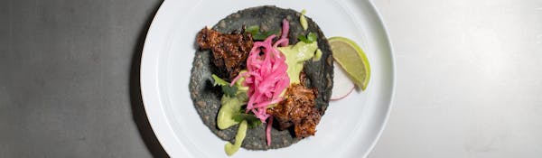 a blue tortilla taco on a plate