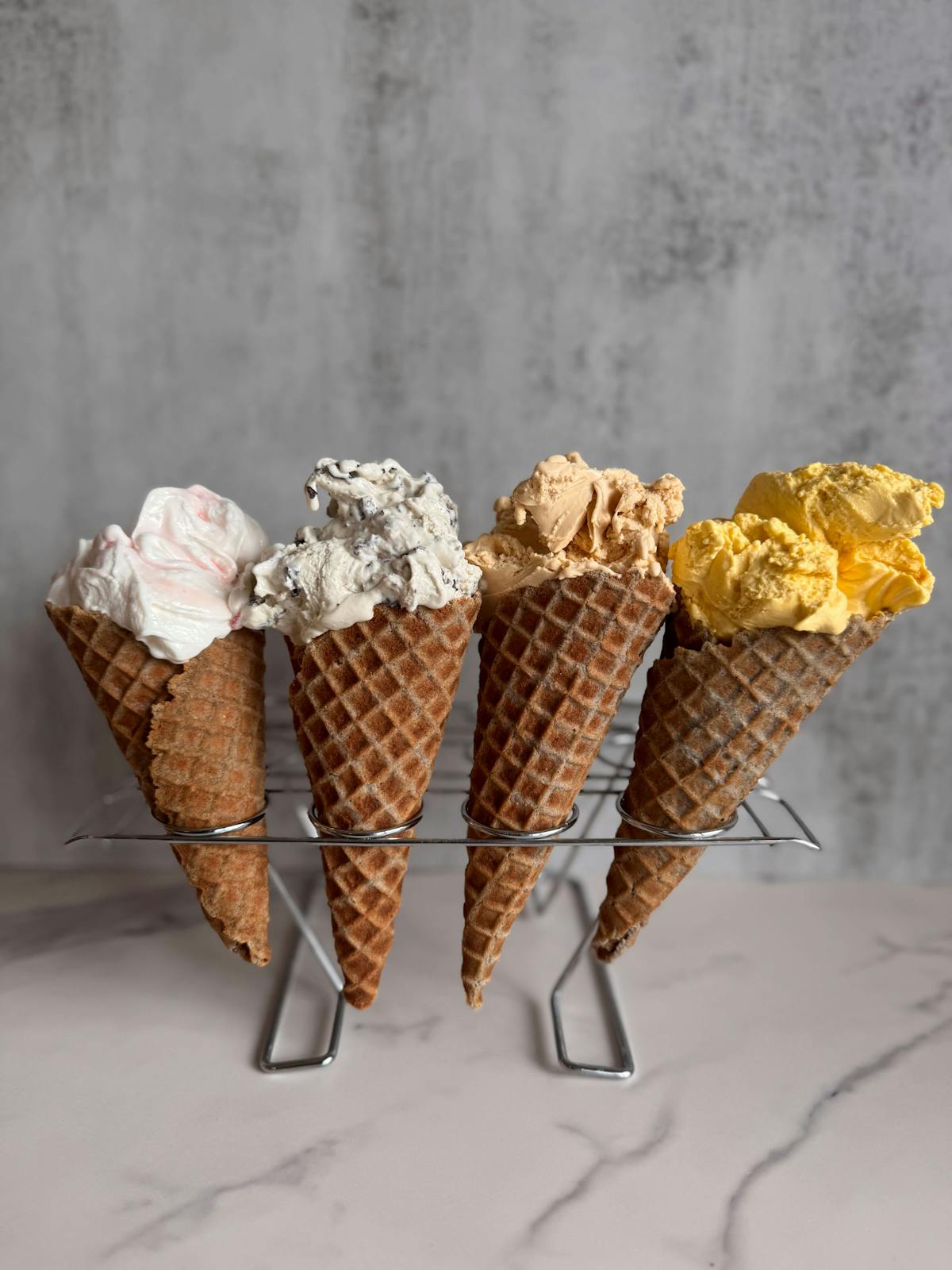 All four Puesto x An’s Gelato flavors in a blue waffle cone