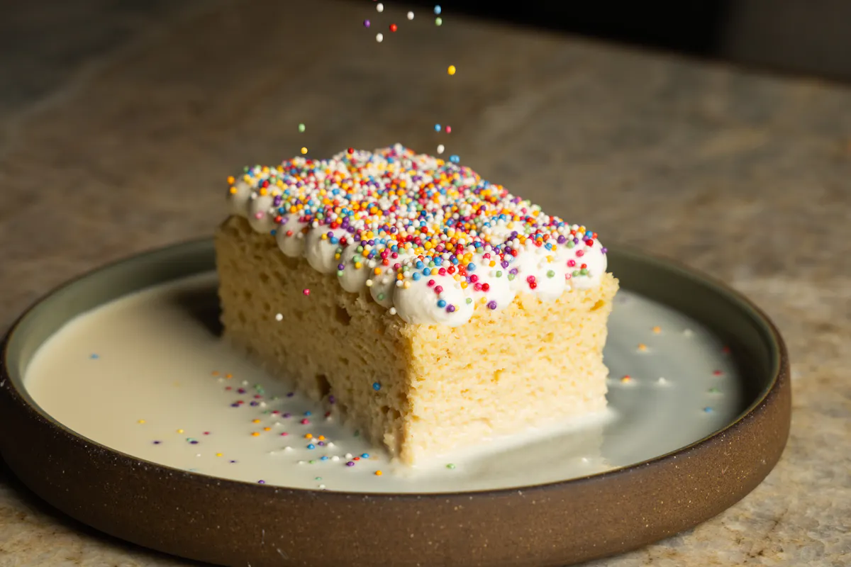 a piece of cake with sprinkles on top