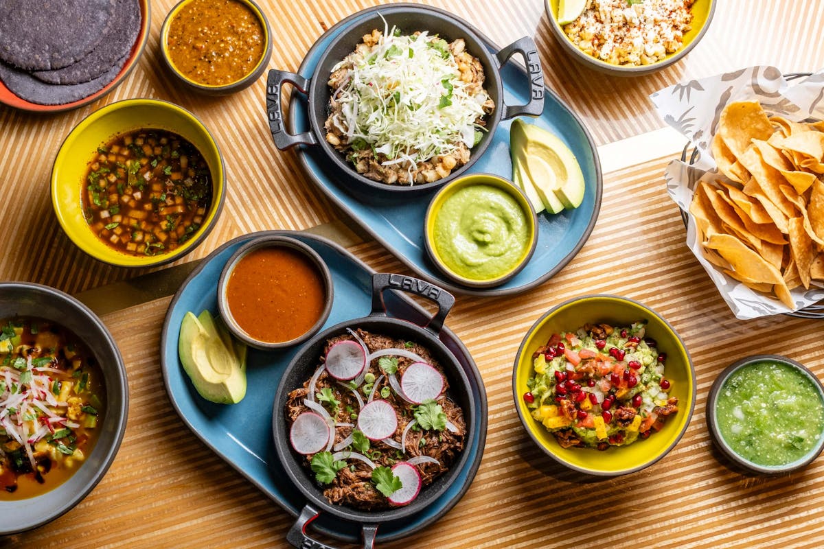 a bunch of food sitting on top of a wooden table