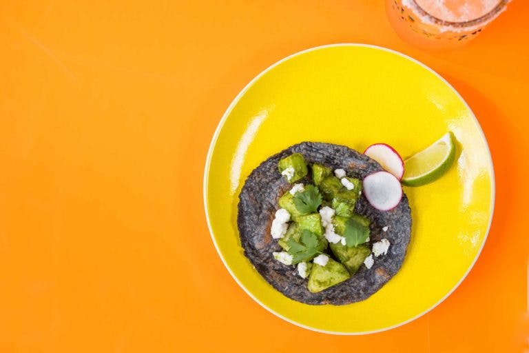a plate of food and on an orange colored table