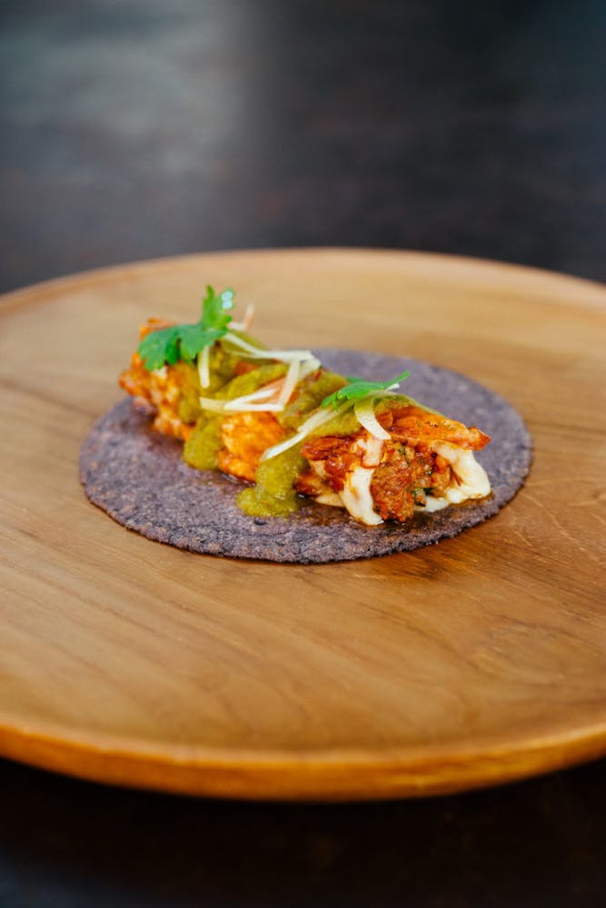 a close up of a taco on a wooden table