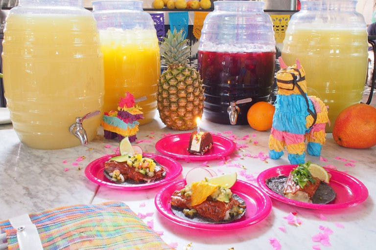 a table topped with plates of food and drinks