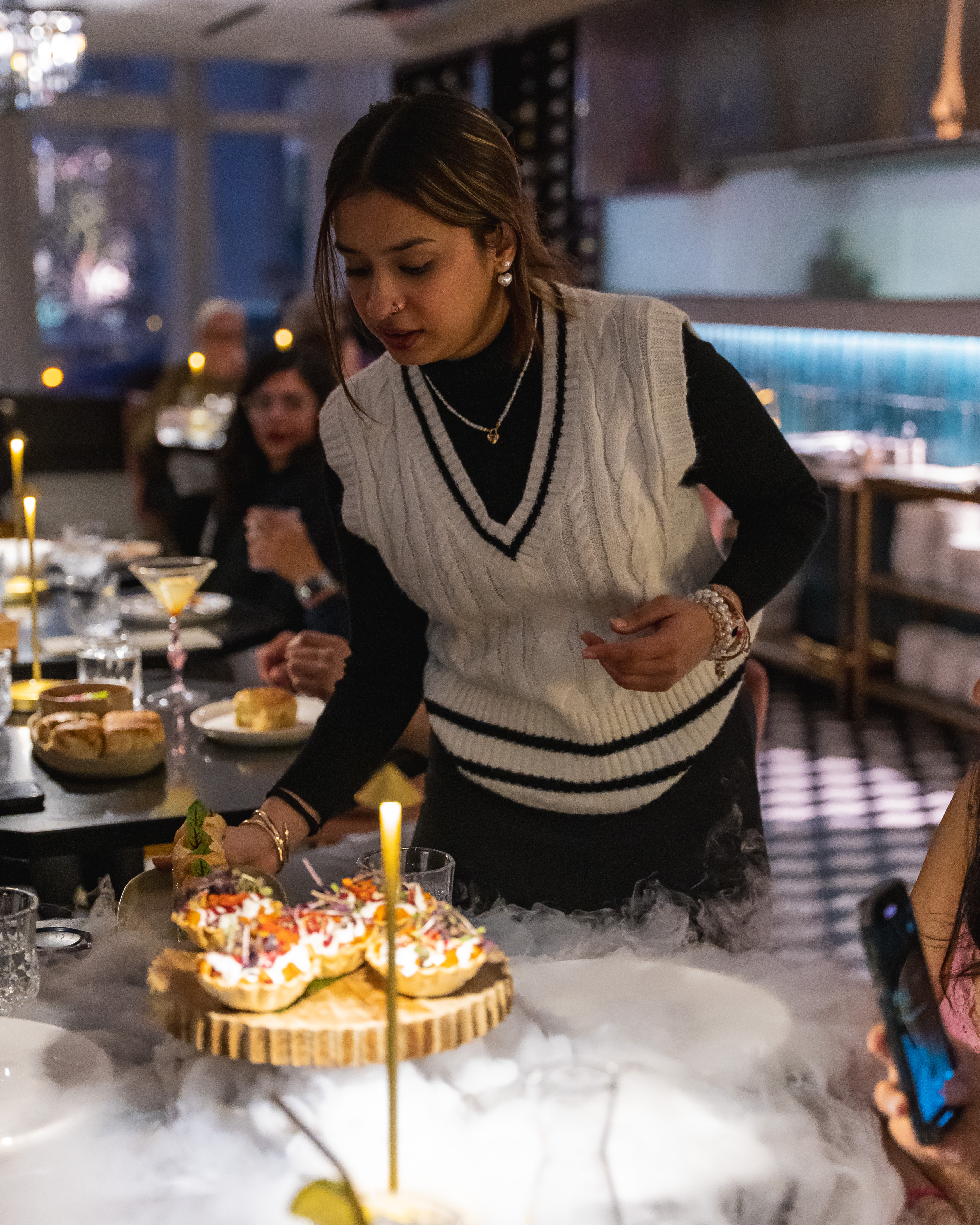 a person sitting at a table with a birthday cake