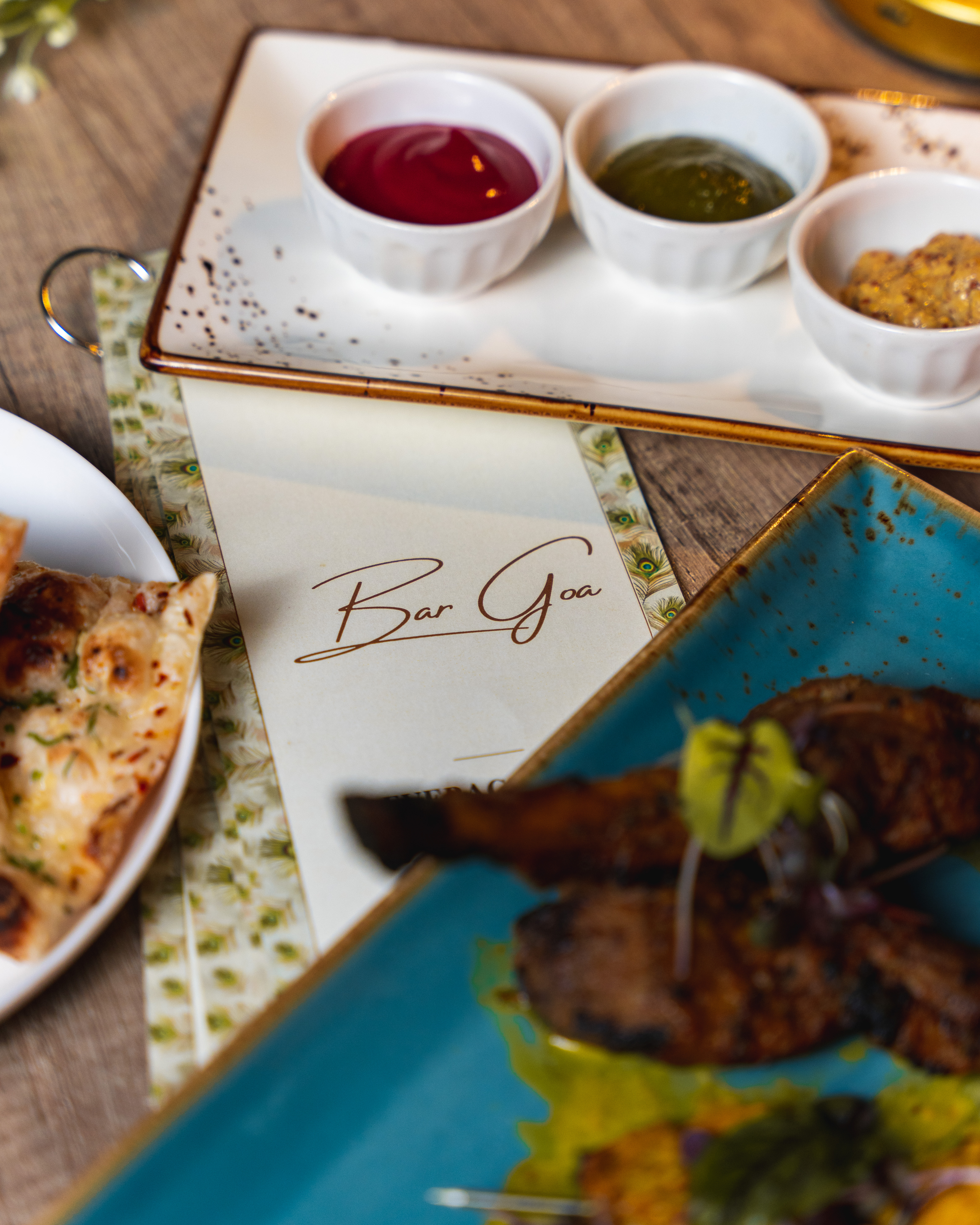 a plate of food with a slice of pizza on a table