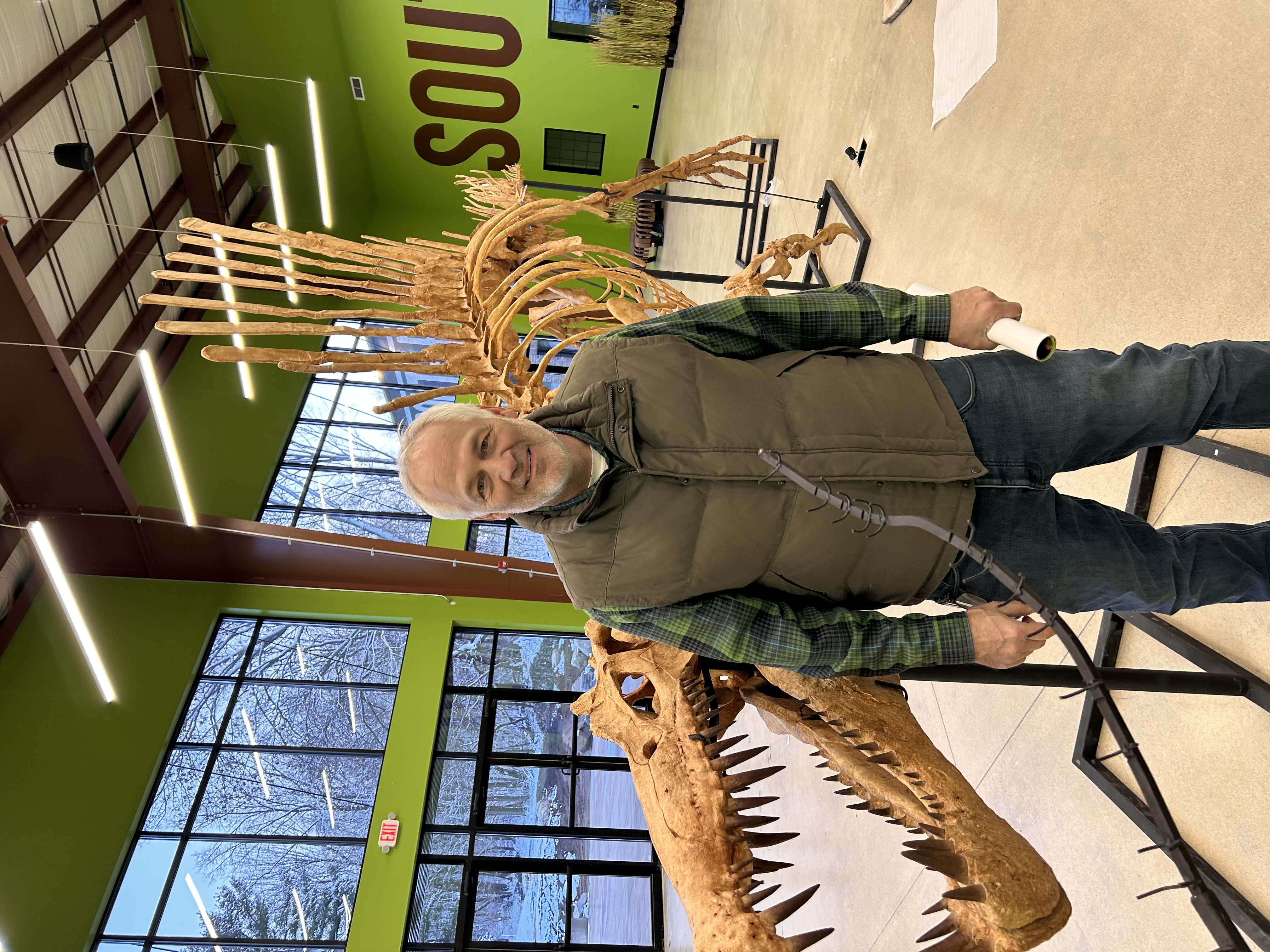 a person standing next to a fence