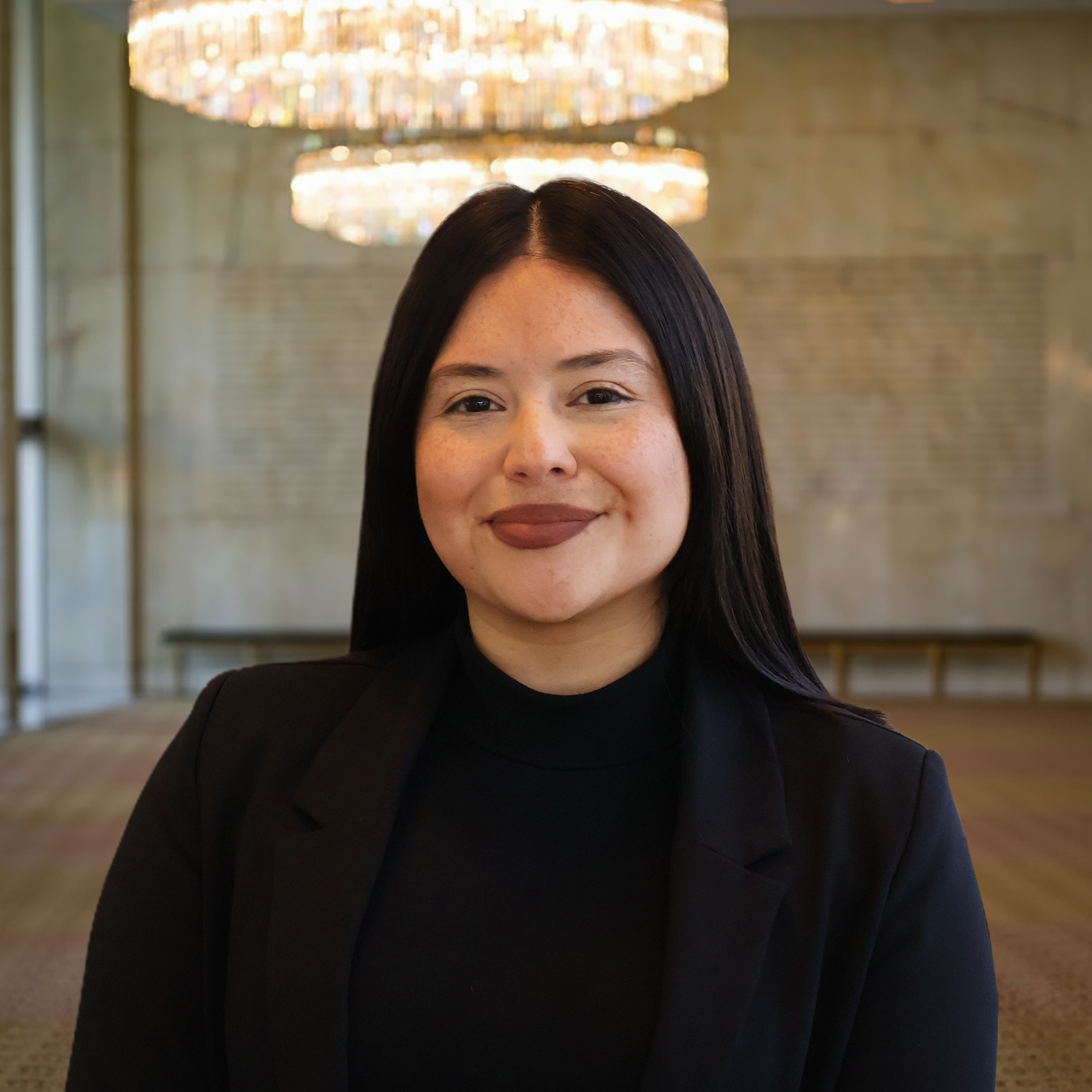 a woman in a room with chandeliers
