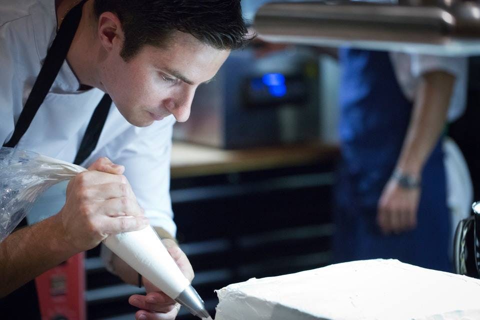 a man cutting a cake