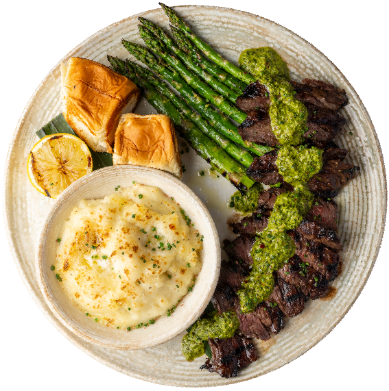 Pacific Catch Chimichurri Skirt Steak with grilled asparagus, creamy mashed potatoes, toasted rolls and grilled lemon.