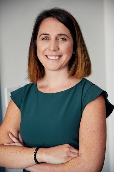 a smiling woman in a green shirt