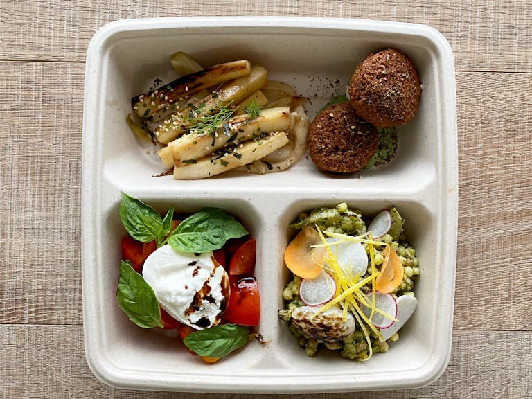 a bento box filled with different types of food on a table