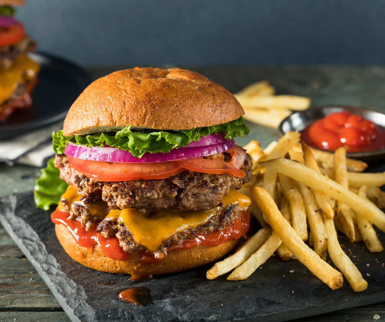 a sandwich is sitting on the side of fries