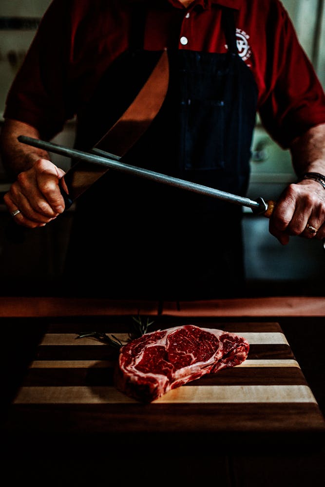 a man sitting at a table with a knife