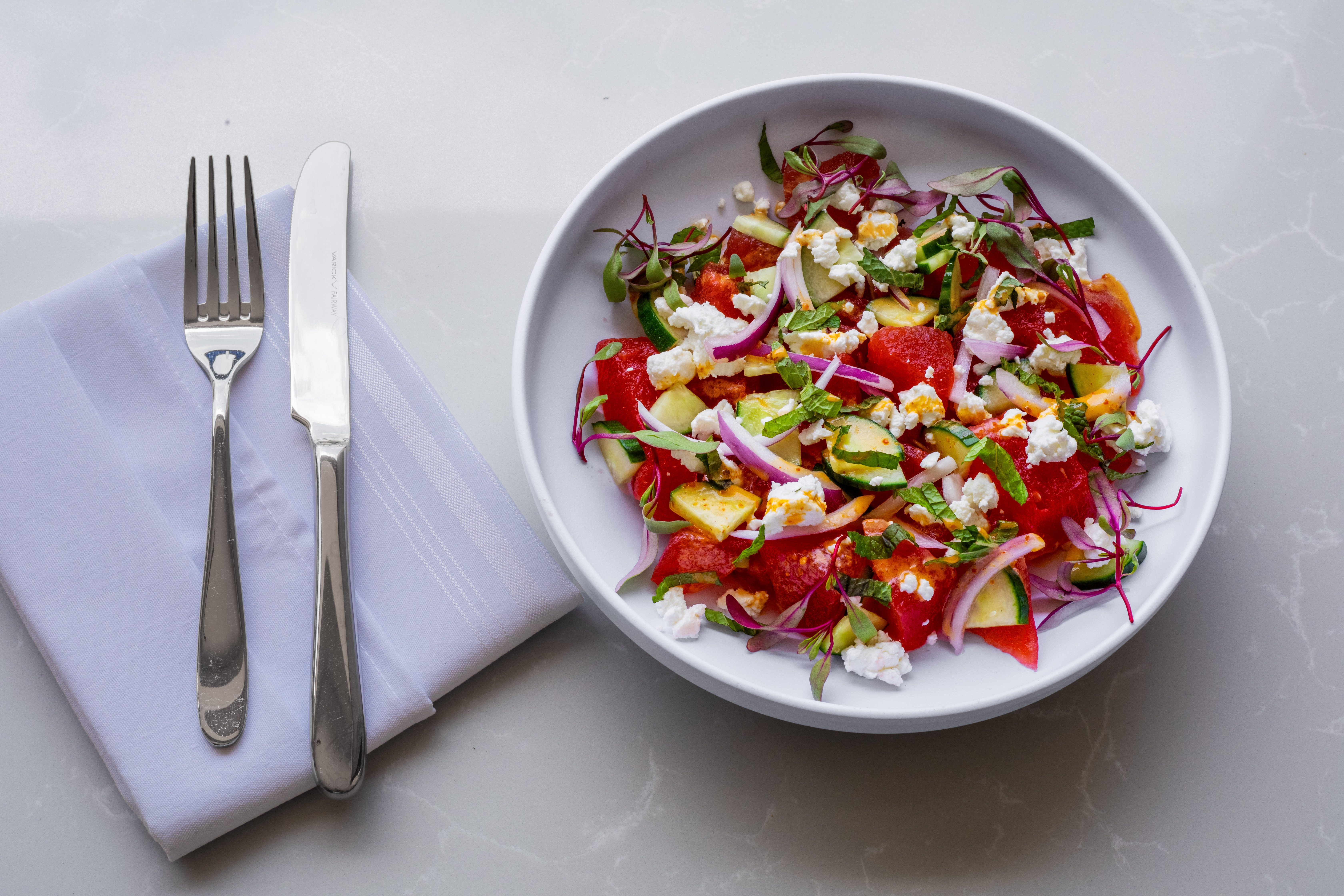 a bowl of salad on a plate