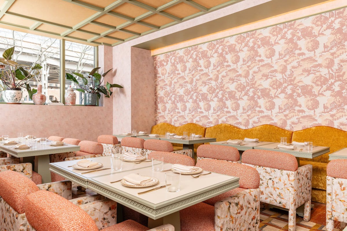 a dining room table with plates over the table