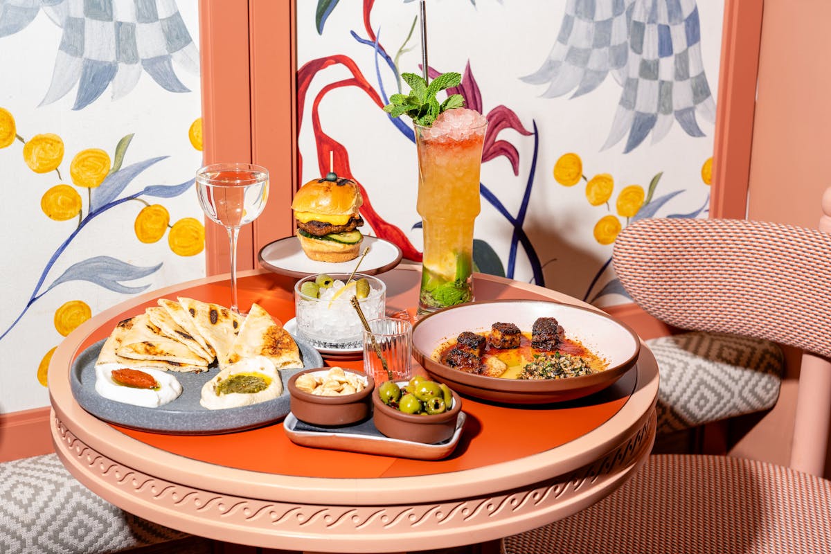a person sitting at a table with a plate of food