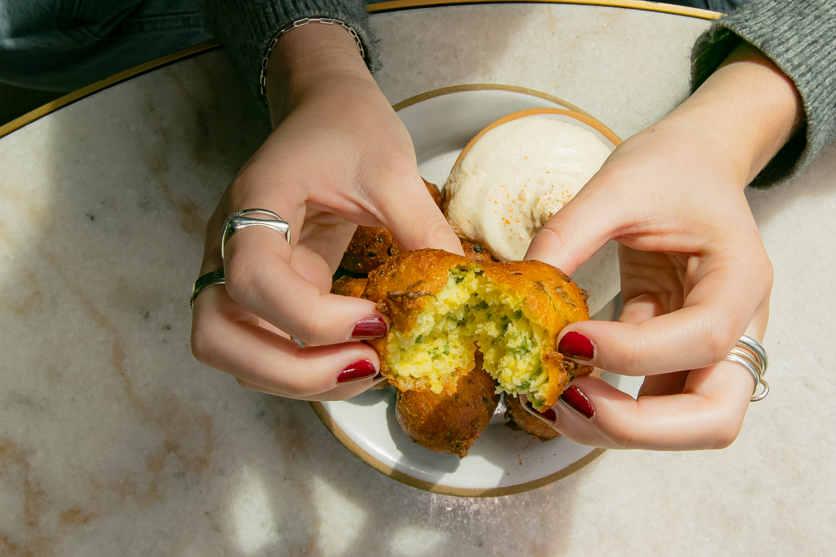 a person holding food on a plate