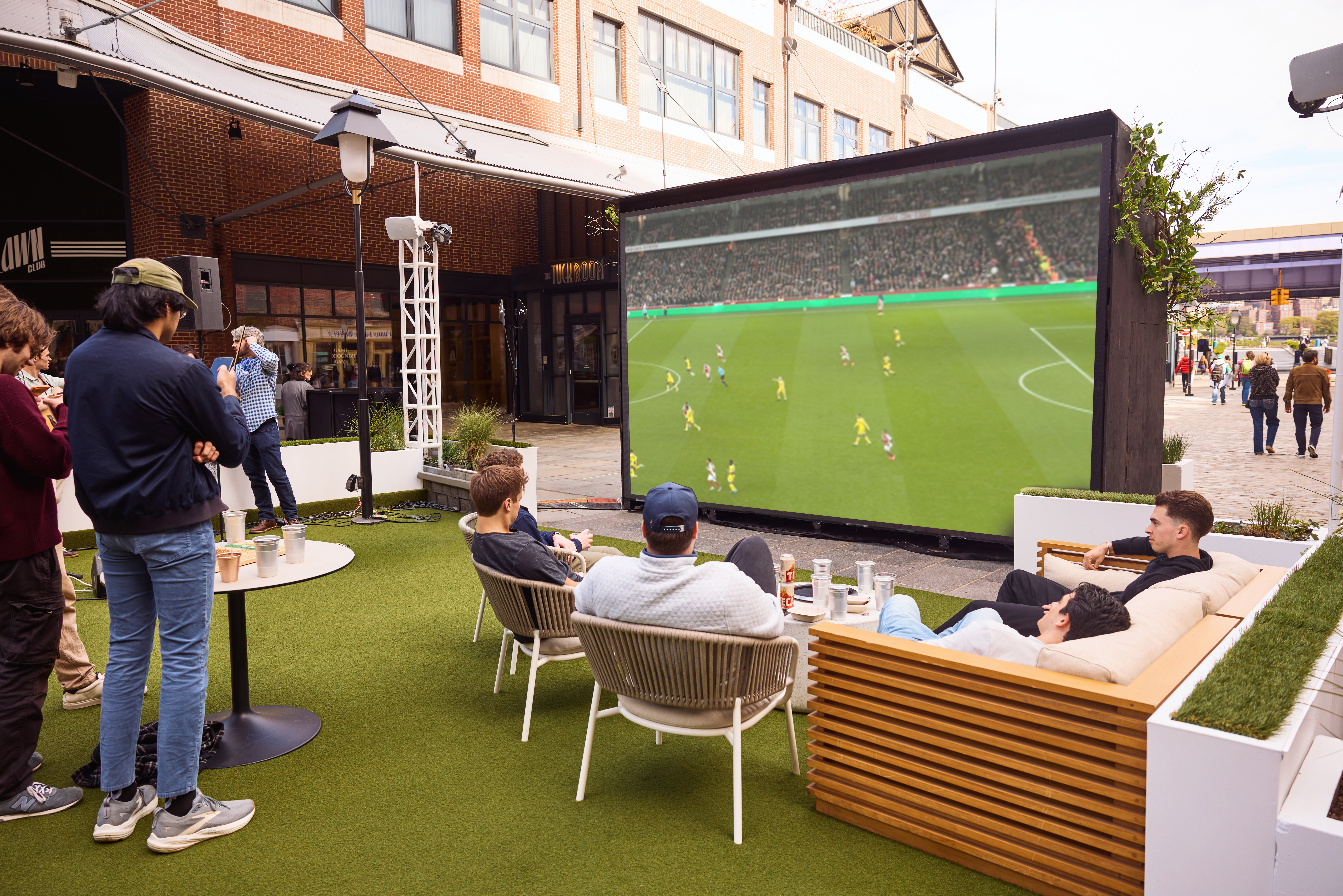 a group of young men watch the world cup on the big screen at sadie's garden bar