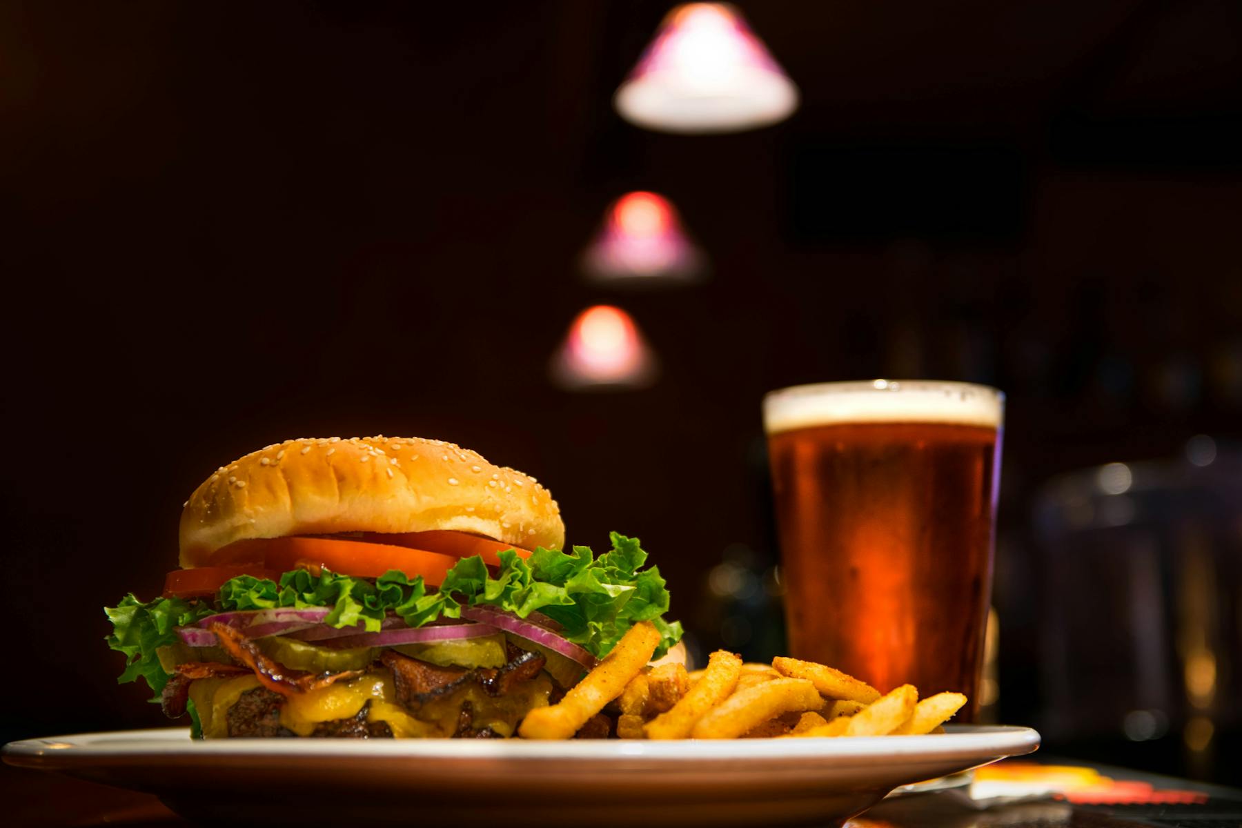 a plate of food and a glass of beer on a table