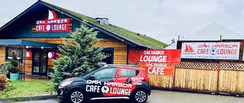 a car parked in front of a sign