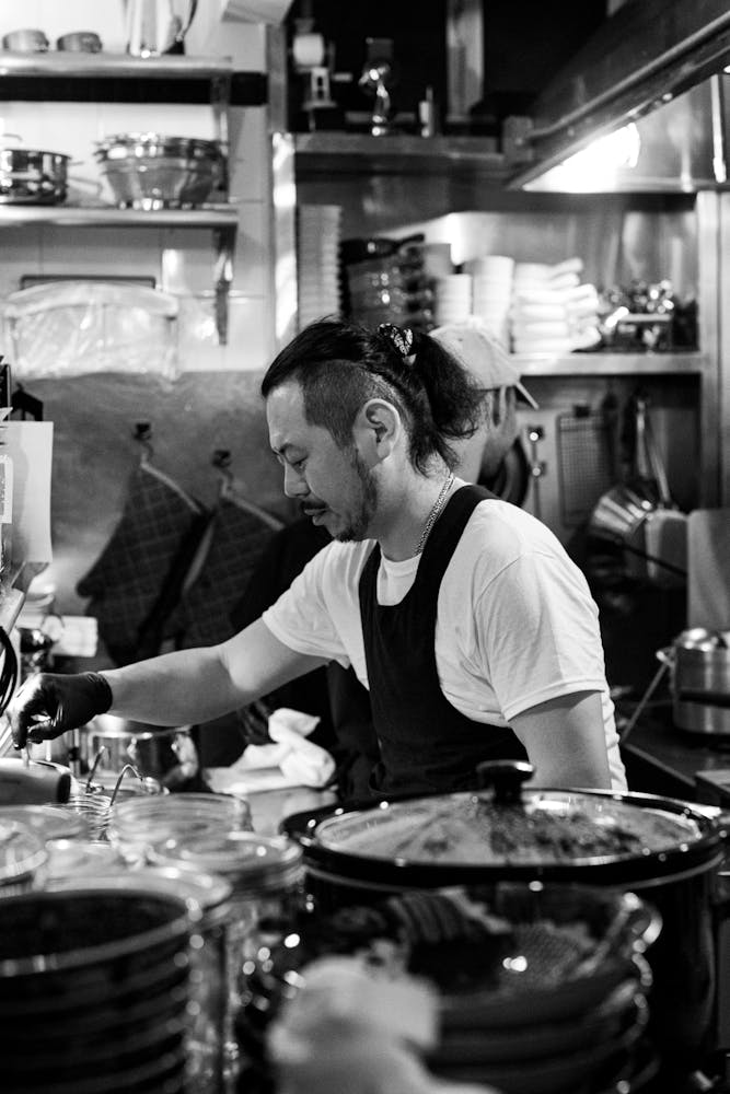 a man cooking in a kitchen preparing food