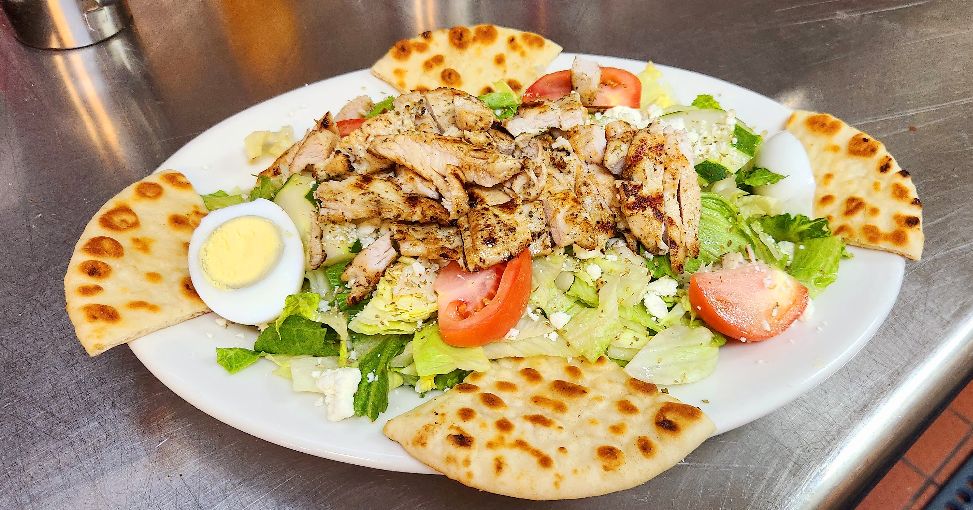 a plate of food with a slice of pizza