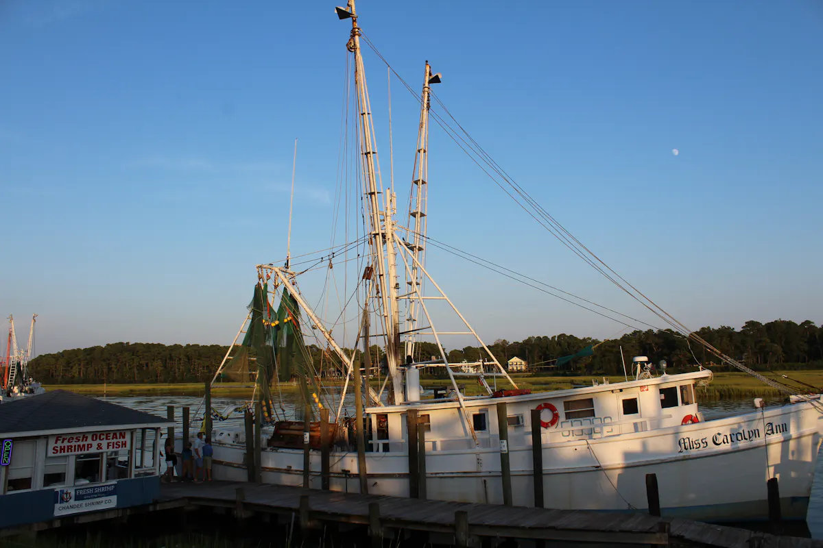 a boat is docked next to a body of water