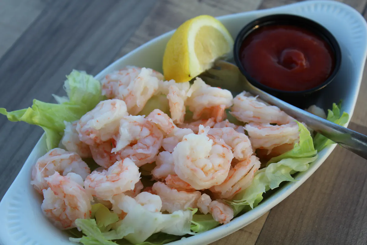 a plate with shrimp and salad