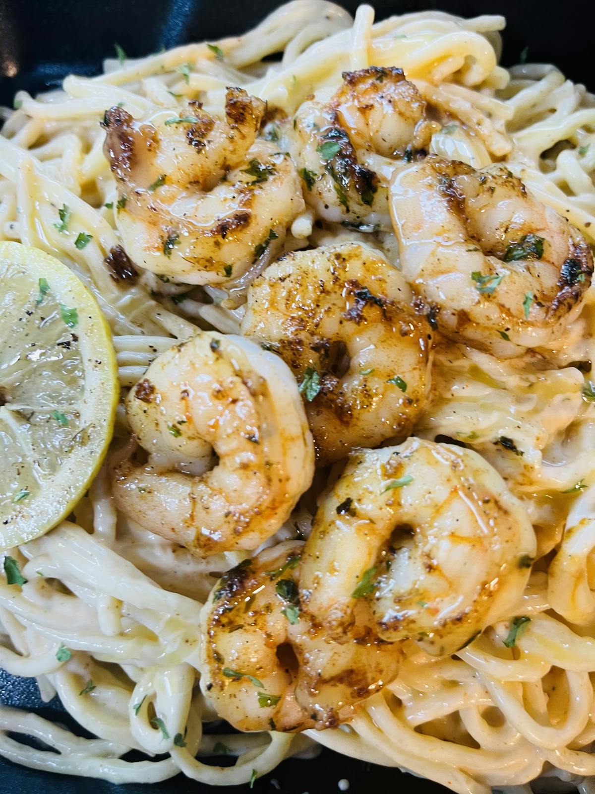 a close up of pasta with shrimp