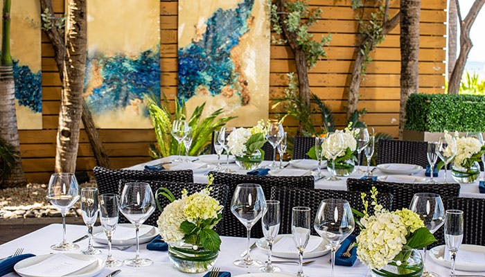 a group of people sitting at a table with wine glasses