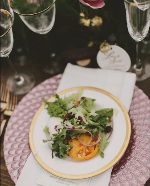 a plate of food and a glass of wine