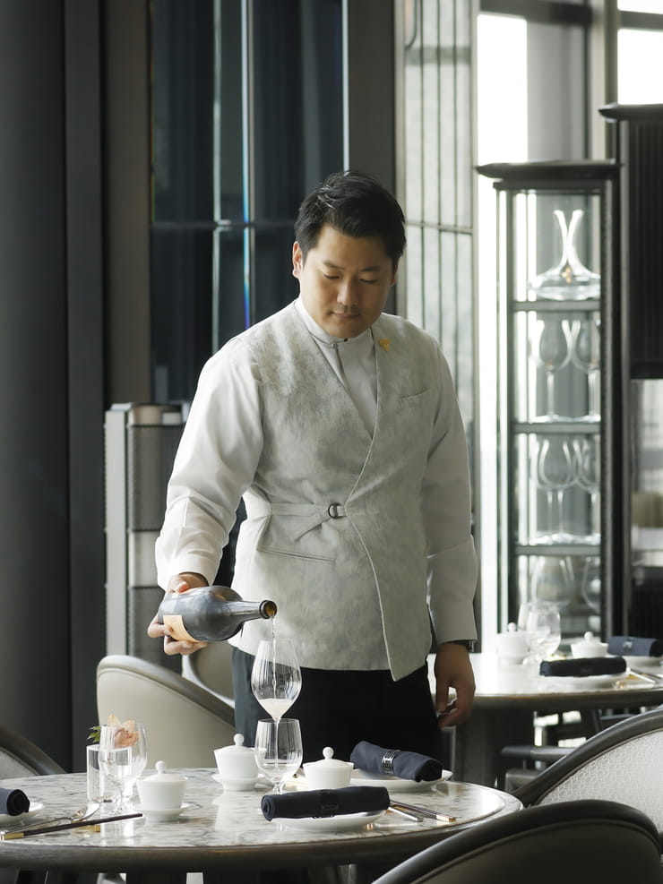 a man pouring wine into a glass
