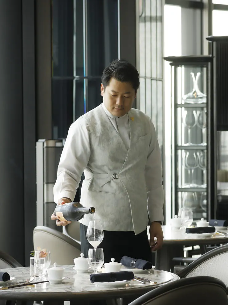 a man pouring wine into a glass