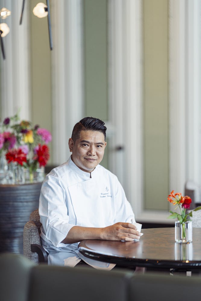 a man sitting at a table using a laptop