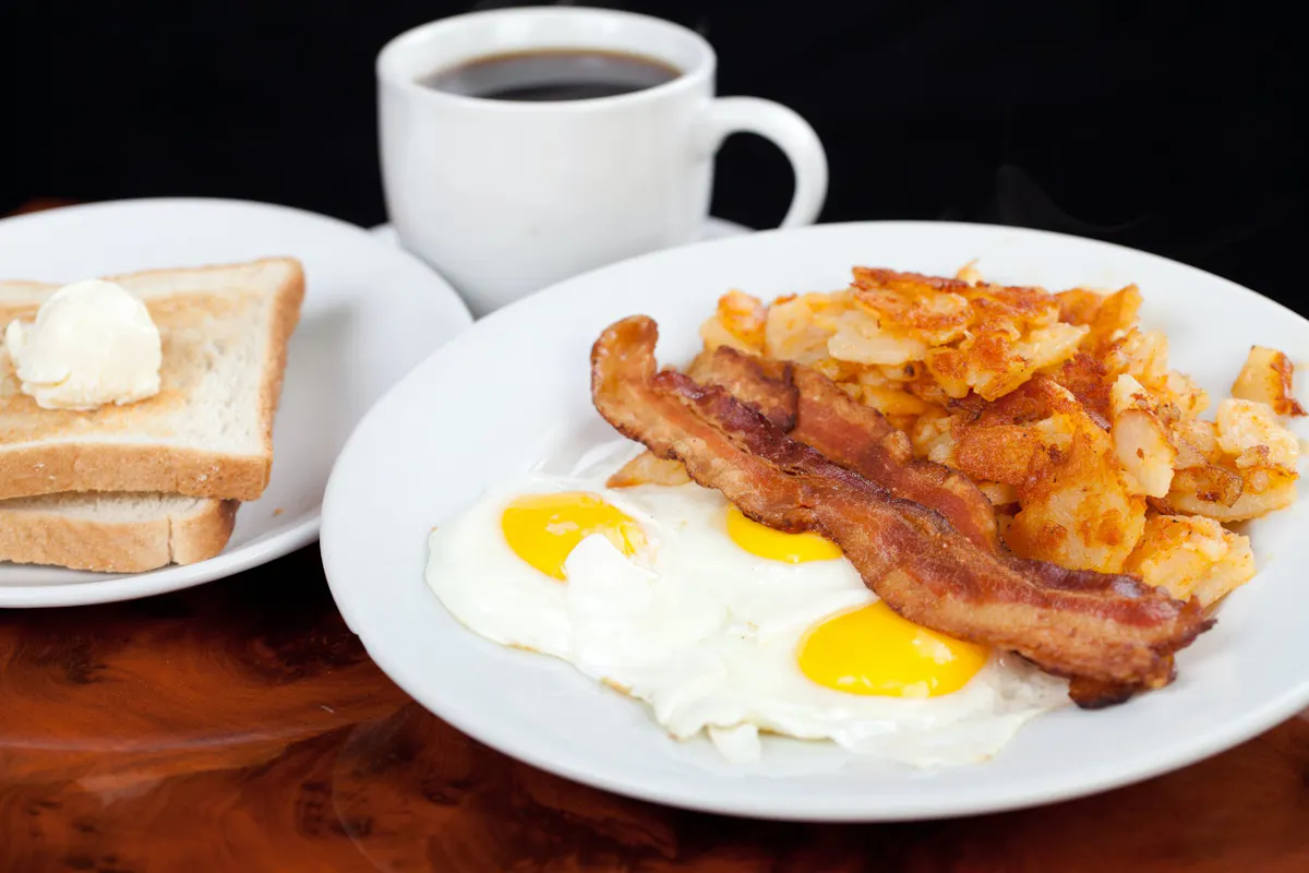a plate of food and a cup of coffee
