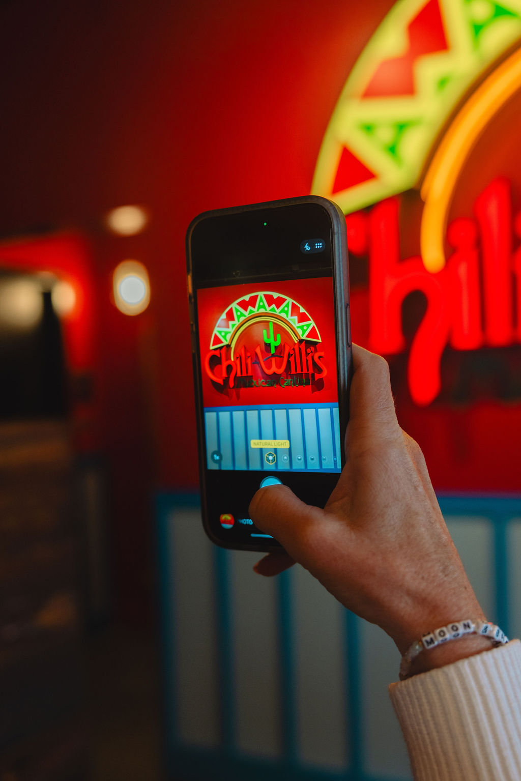 a hand holding a phone with a screen on it