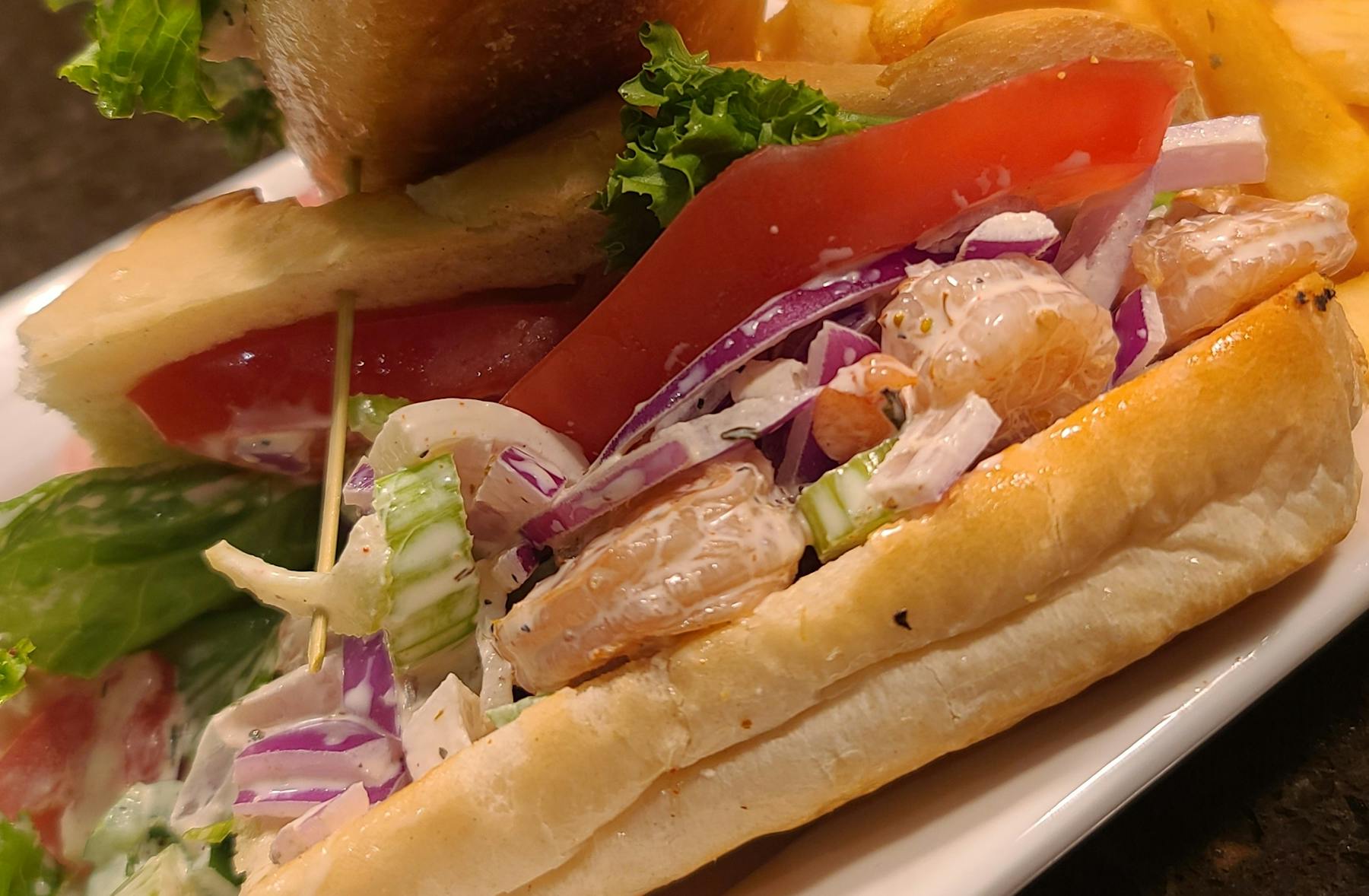 a close up of a sandwich with meat and vegetables