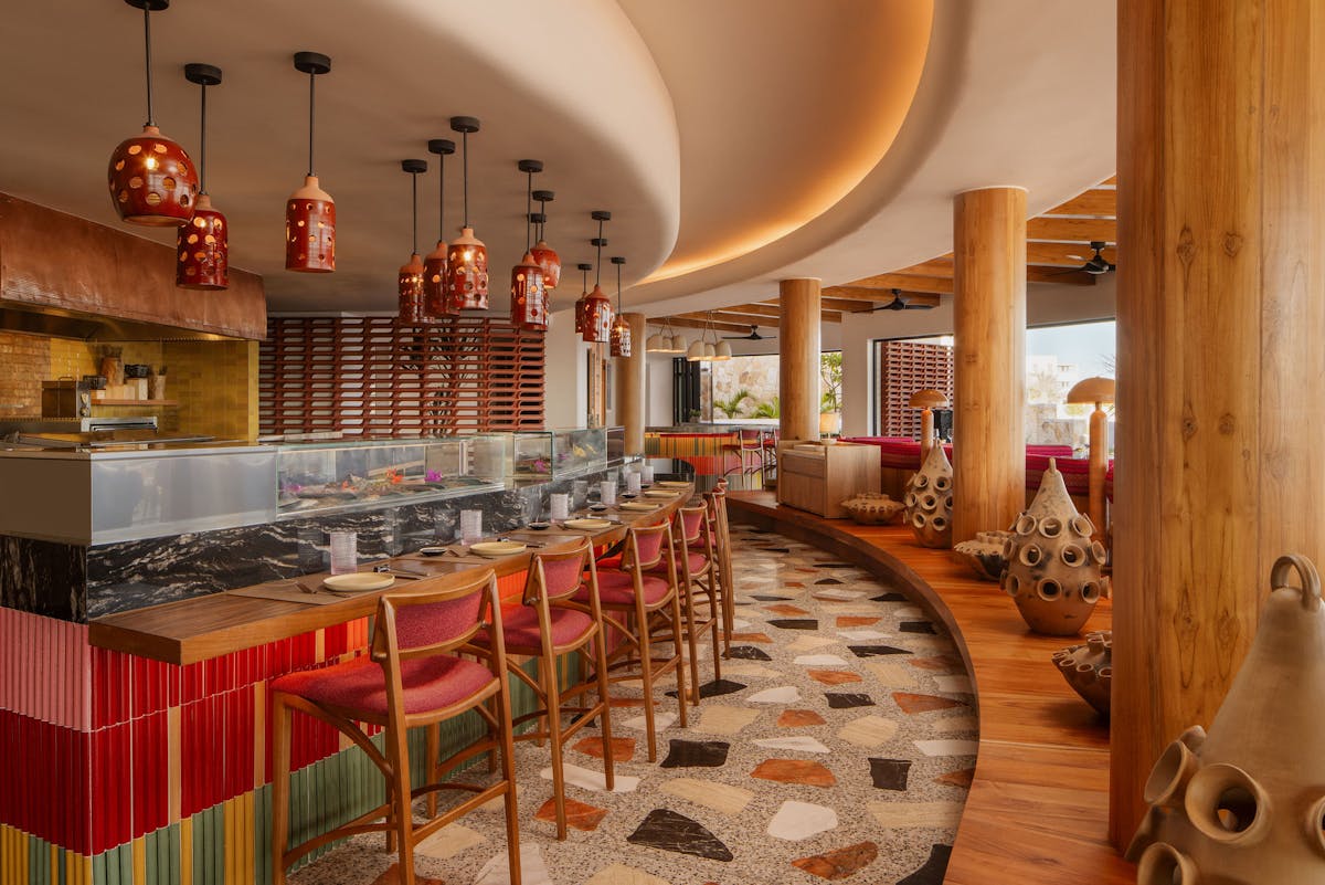 A lively restaurant scene showcasing a colorful bar and an assortment of vibrant chairs for guests to enjoy