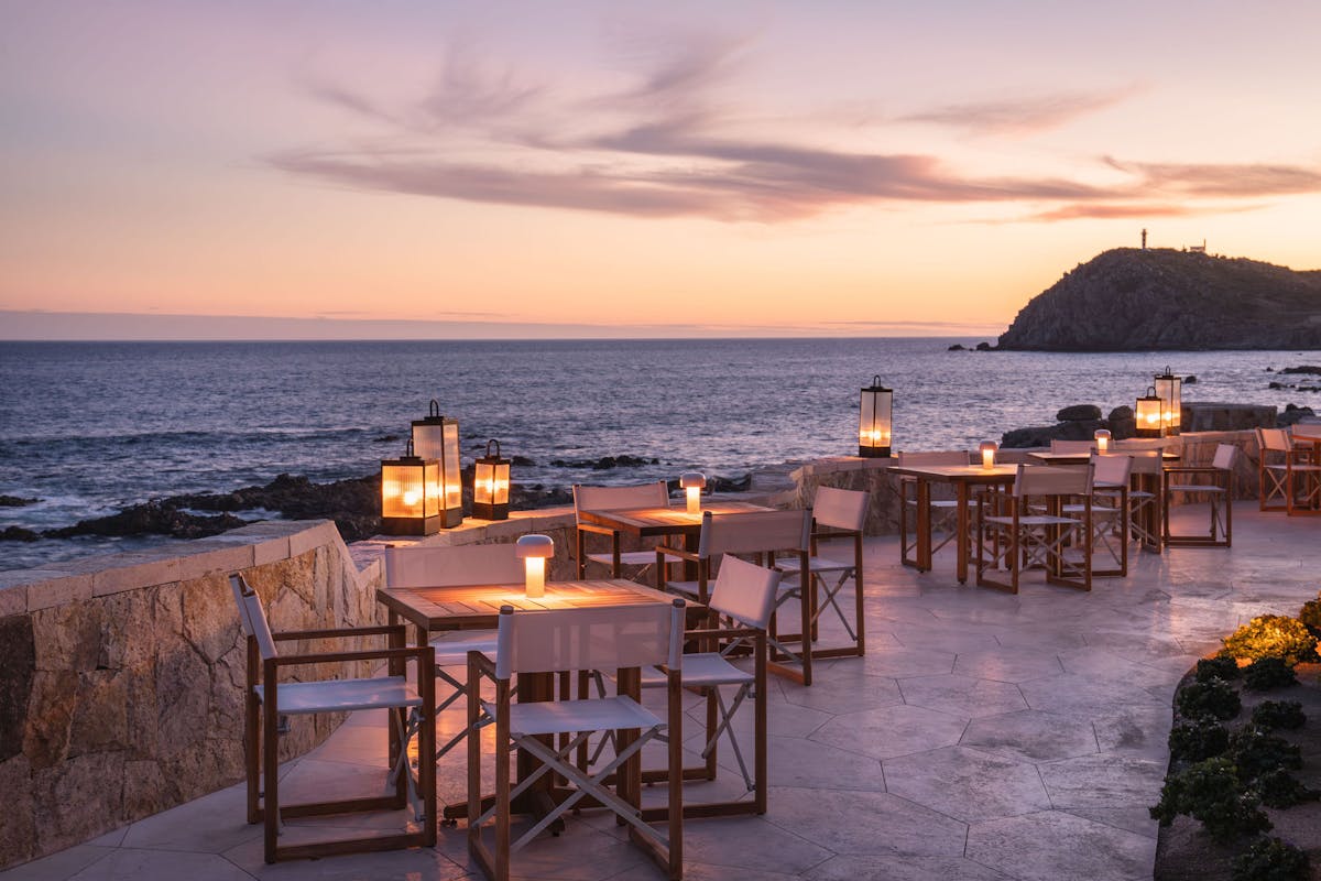 a chair sitting in front of a body of water