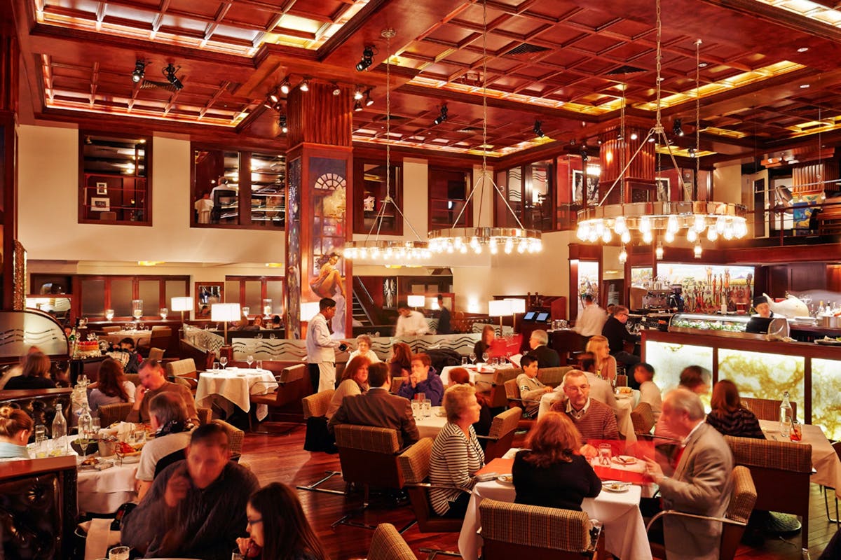 a group of people sitting at a table in a restaurant