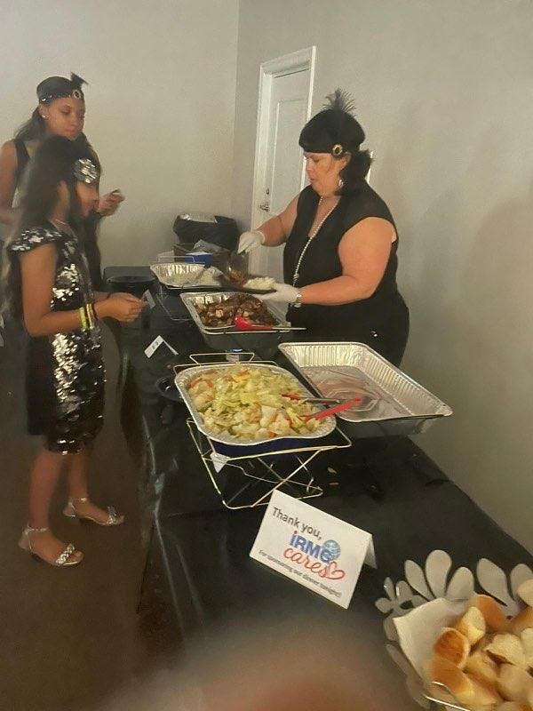 a group of people preparing food on a table