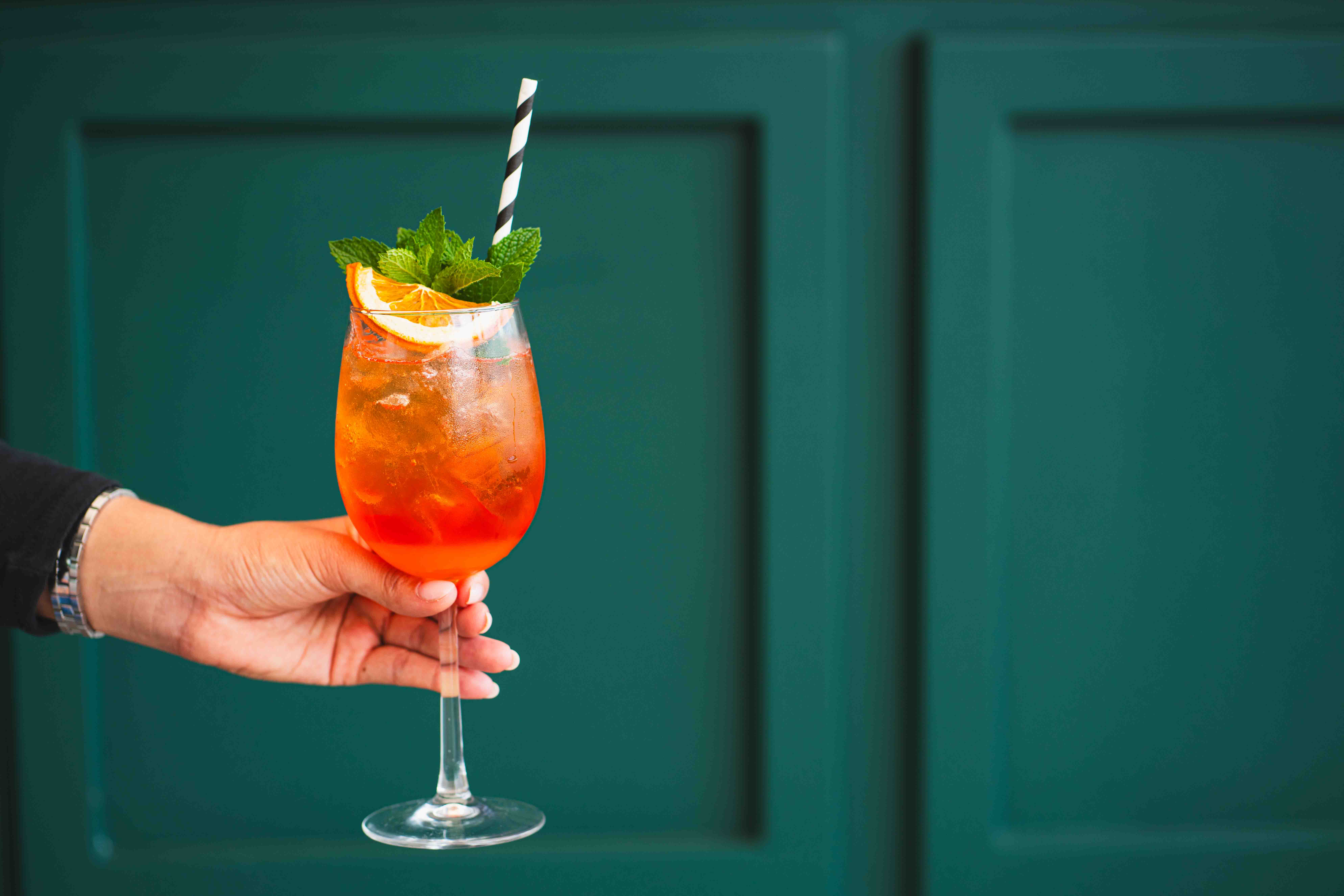 a hand holding a glass of wine