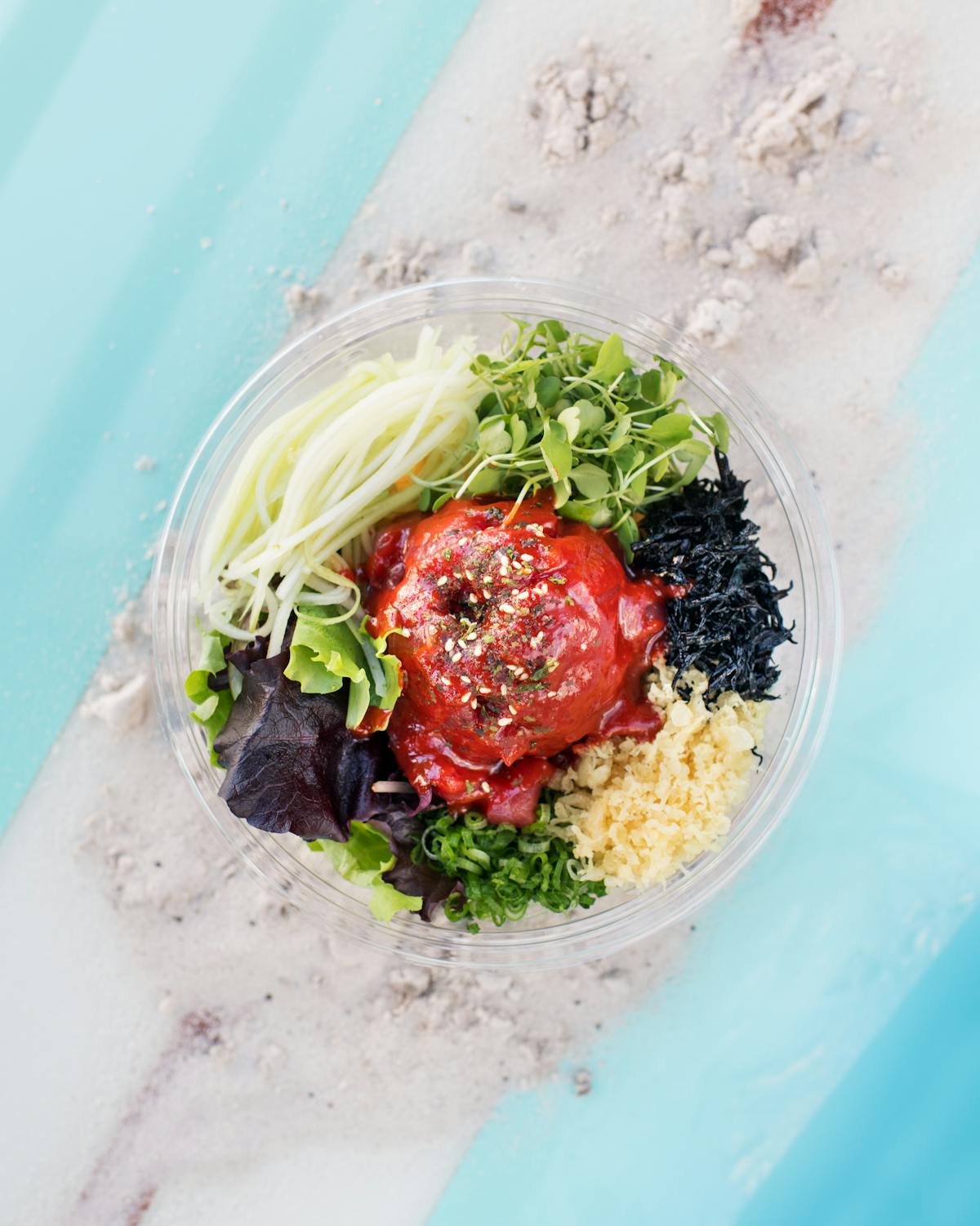 a close up of a plate salad on a wooden surface