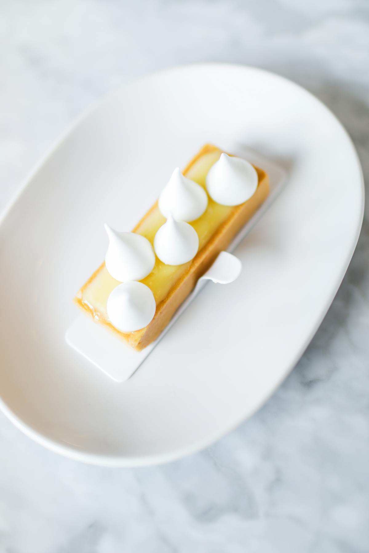 a close up of a bun topped with whipped cream