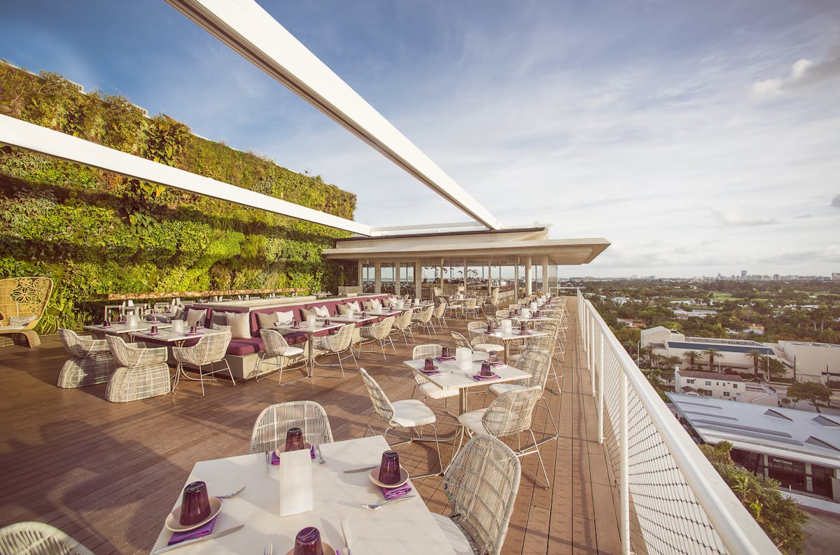 a patio filled with tables and chairs