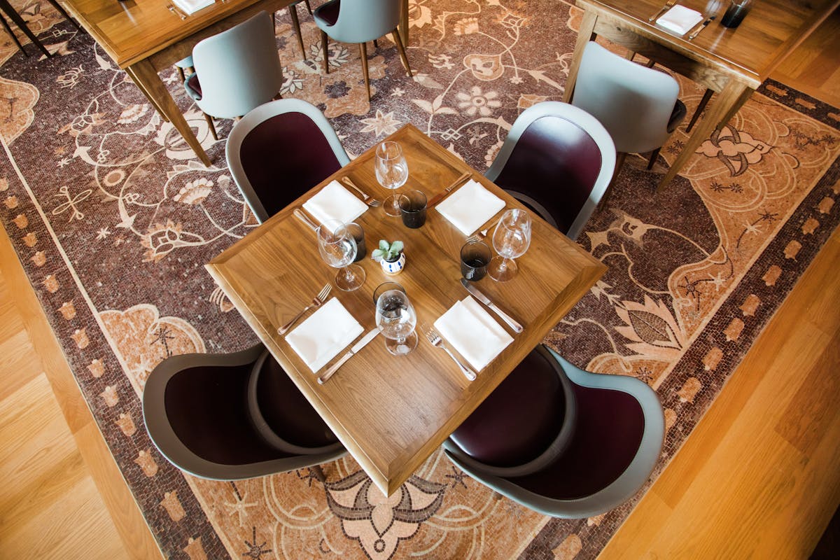 a close up of a dining table topped with napkins and glasses