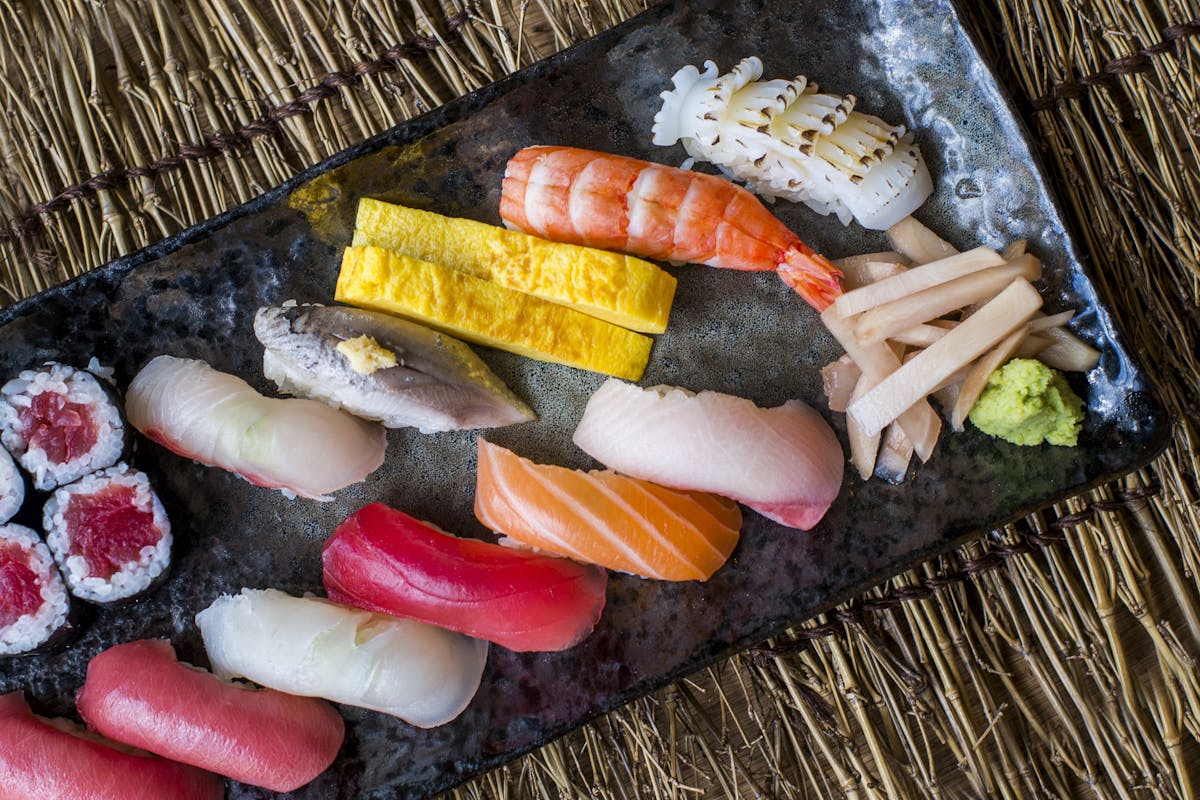 a food tray topped with different sushi rolls