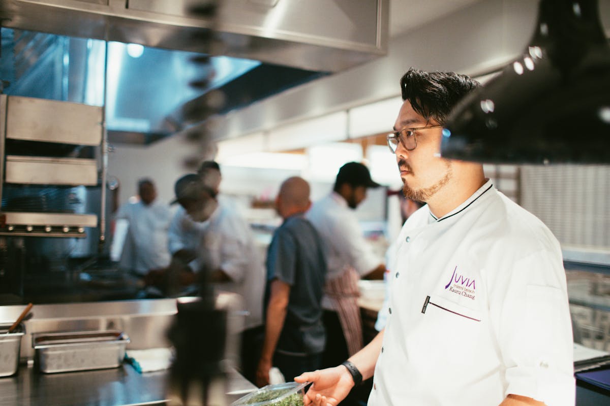 a man standing in a kitchen preparing food