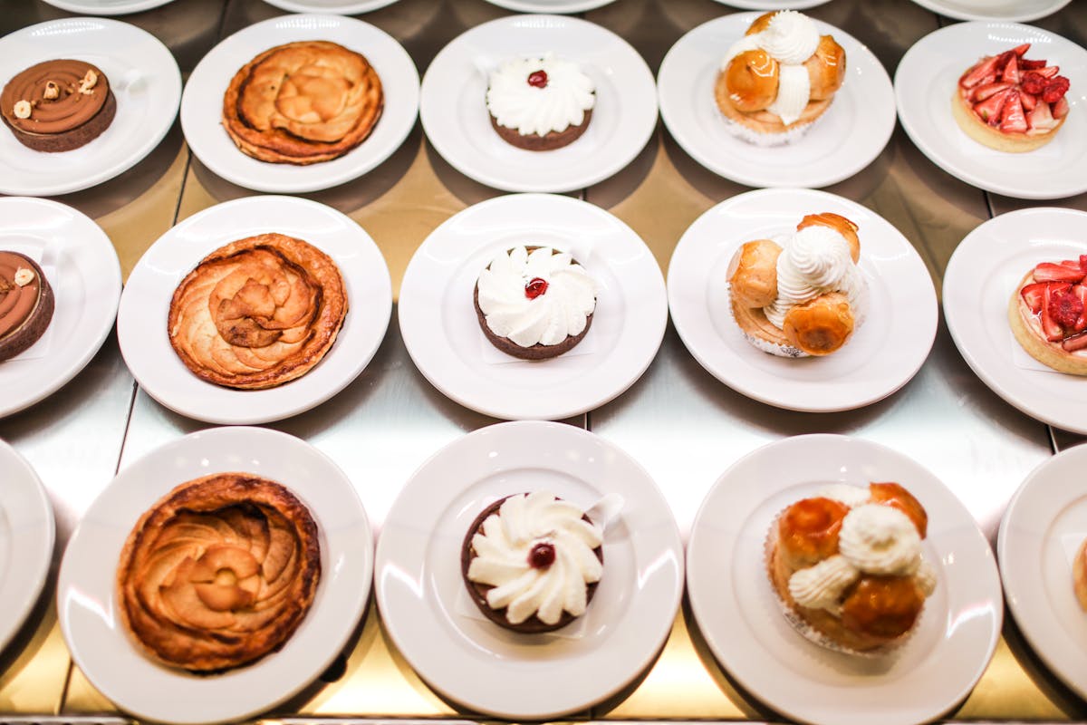 an array of platters topped with different desserts